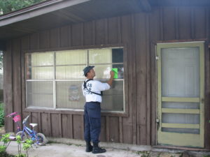 TX-TF2 member marking a search sticker on a house