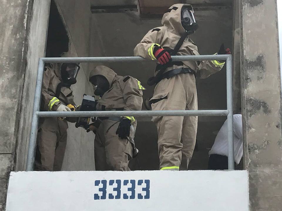 TX-TF2 members in full HazMat gear on a balcony during a training exercise