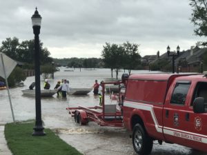 TX-TF2 members unloading flat bottom boats into floodwater